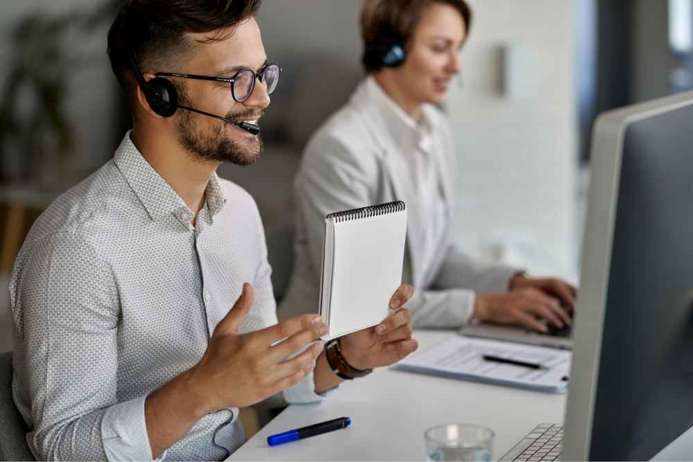 happy-customer-service-representative-using-computer-having-video-call-with-clients-while-working-call-center