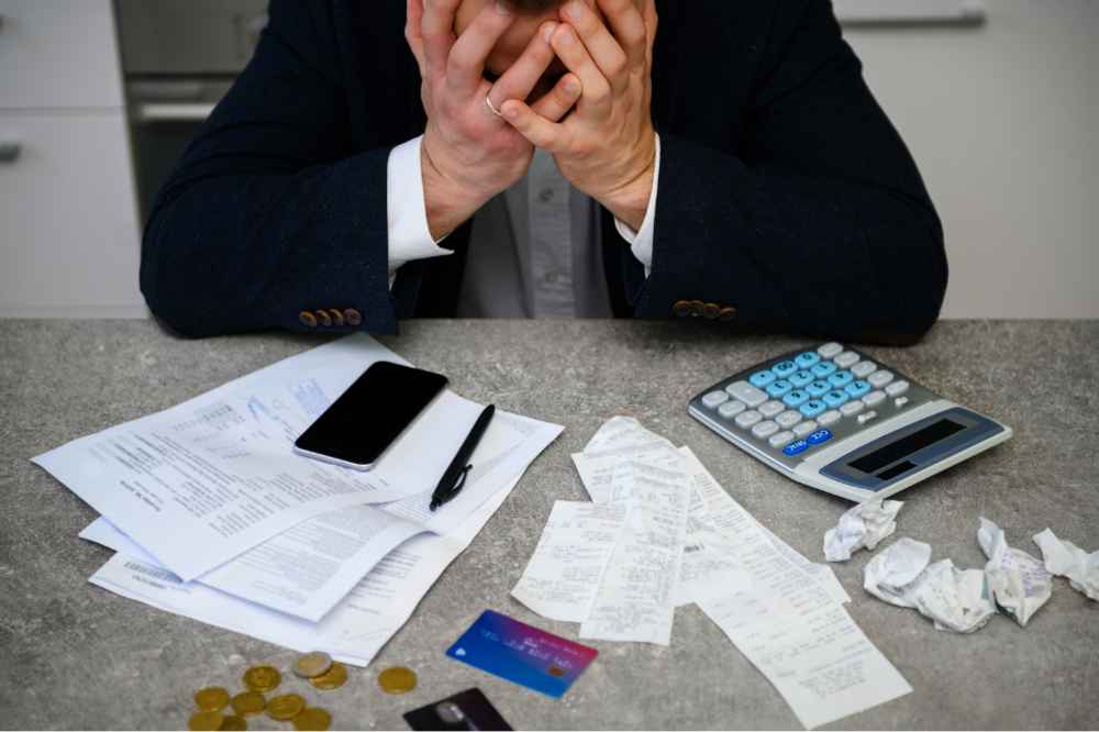 worried-man-calculating-budget-finances